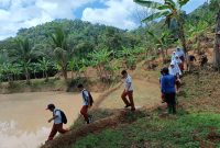 Para pelajar SDN 1 dan 3 Cikamunding saat akan pergi sekolah. Mereka terpaksa melewati persawahan dan hutan agar lebih cepat datang ke sekolah. (Istimewa)
